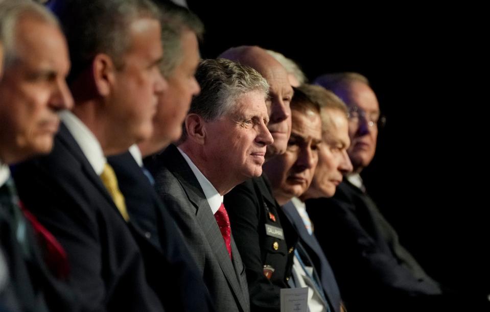 Gov. Dan McKee sits among his Cabinet and legislative leaders at his inauguration on Tuesday.