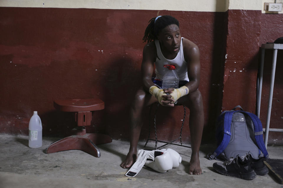 Transgender Cuban athlete Ely Malik Reyes, who practices mixed martial arts known as sanda, rests during a workout at a gym in Regla, across the bay from Havana, Cuba, Tuesday, June 11, 2024. Reyes became the first trans athlete to officially compete in a Cuban league. (AP Photo/Ariel Ley)