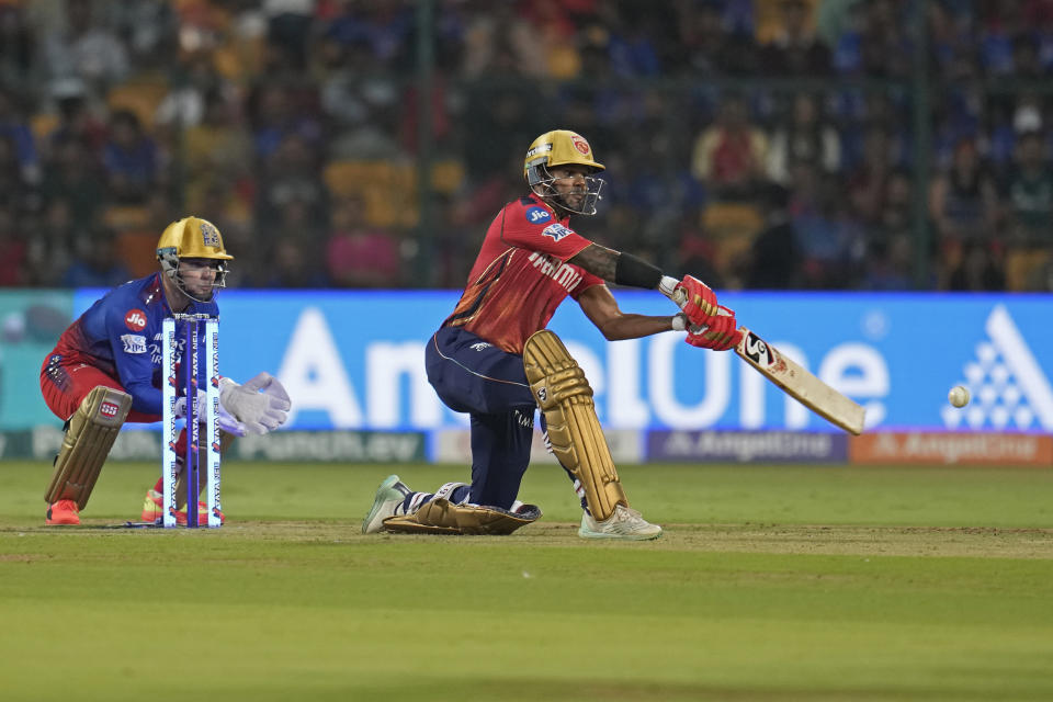 Punjab Kings' captain Shikhar Dhawan plays a shot during the Indian Premier League cricket match between Royal Challengers Bengaluru and Punjab Kings in Bengaluru, India, Monday, March 25, 2024. (AP Photo/Aijaz Rahi)