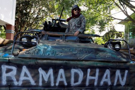 A Philippines army soldier stands on a tank inside the city hall compound in Marawi as government forces continue their assault against insurgents from the Maute group, who have taken over large parts of Marawi City , Philippines June 25, 2017. REUTERS/Jorge Silva