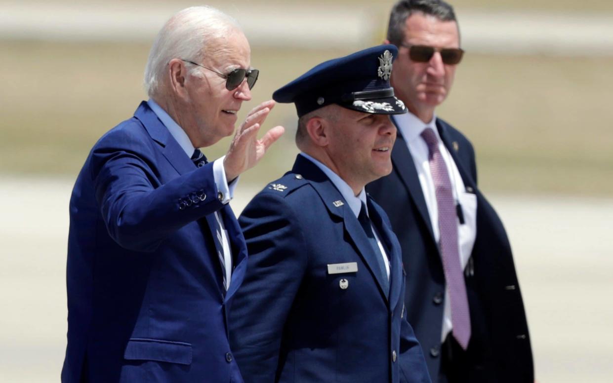 Biden waves as he arrives