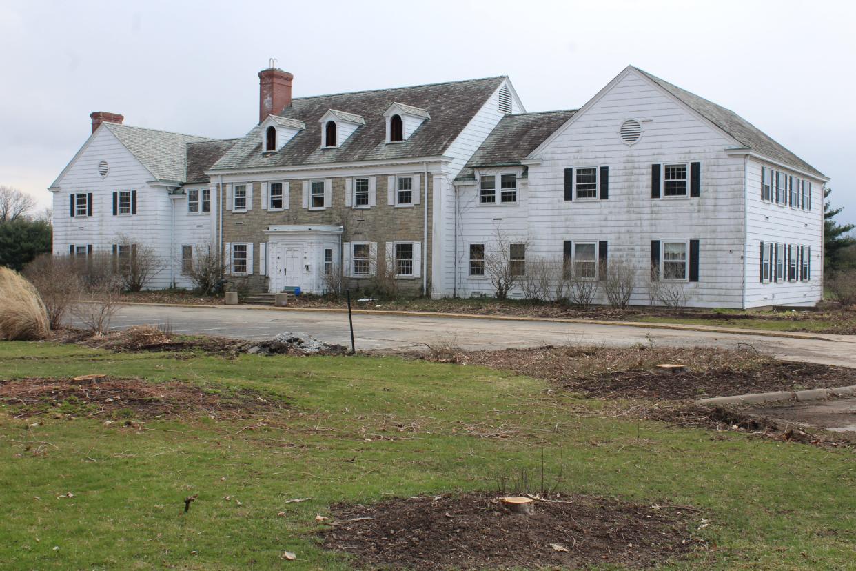 The Wooster Inn sits surrounded by a lawn made empty with the recently cut-down trees.