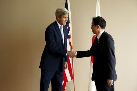Japan's Foreign Minister Fumio Kishida (R) greets U.S. Secretary of State John Kerry before their bilateral meeting alongside the G7 foreign ministers meetings in Hiroshima, Japan April 11, 2016. REUTERS/Jonathan Ernst
