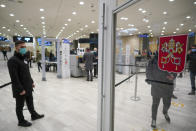 Museums' workers wait for visitors at the entrance of the Vatican Museums, at the Vatican, Monday, Feb. 1, 2021 .The Vatican Museums reopened Monday to visitors after 88 days of shutdown following COVID-19 containment measures. (AP Photo/Andrew Medichini)