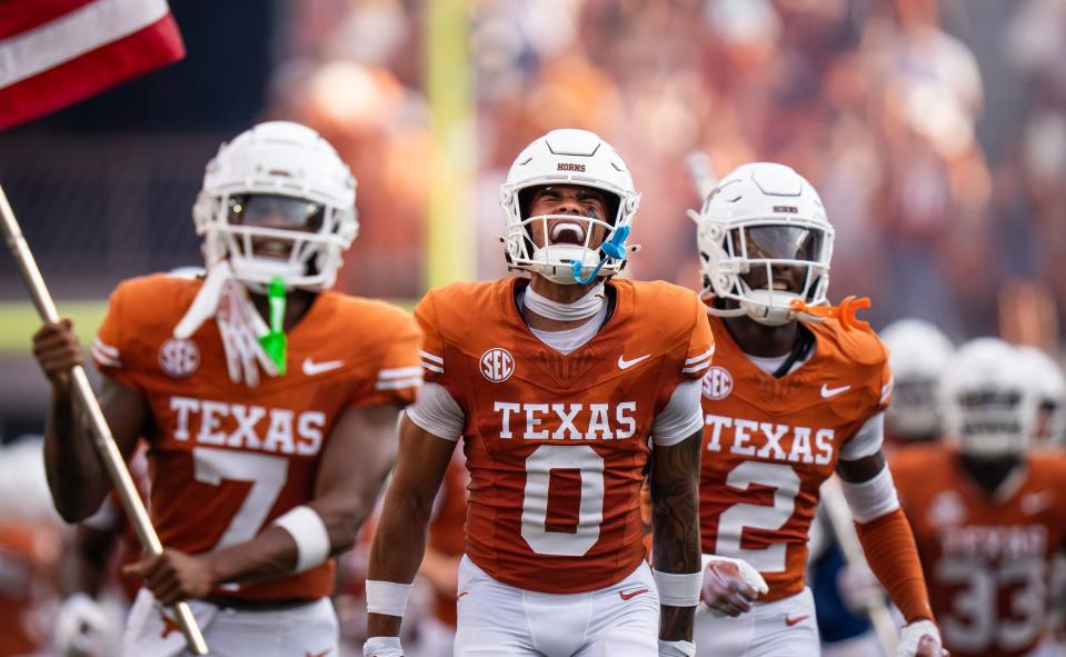 Texas Longhorns wide receiver DeAndre Moore Jr., center, runs out on the field ahead of the Longhorns' game against the UTSA Roadrunners at Royal-Memorial Stadium on Sept. 14.