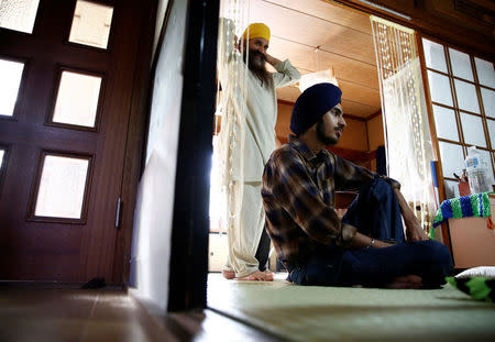 Gursewak Singh (R) and his father Bharpoor Singh are seen in the living room of their house during an interview with Reuters in Matsudo, Japan, September 25, 2016. REUTERS/Kim Kyung-Hoon