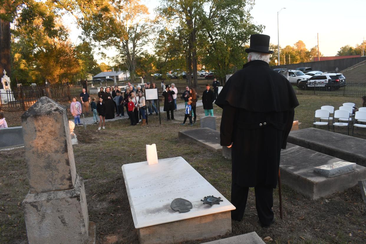 The Historic Rapides Cemetery Preservation Society held an All Souls Day Mass presided over by Father Chad Partain at Old Rapides Cemetery in Pineville. An historic walking tour followed where tour group members learned about some of the historical figures and others buried at the cemetery. The cemetery is located on Hattie Street in Pineville near the Gillis-Long Bridge, known as the Jackson Street Bridge, and dates back over 200 years to when the territory was under Spanish rule. The site is where the house of the first Spanish Commandant Etienne Marafet Layssard of El Rapido Post once stood.