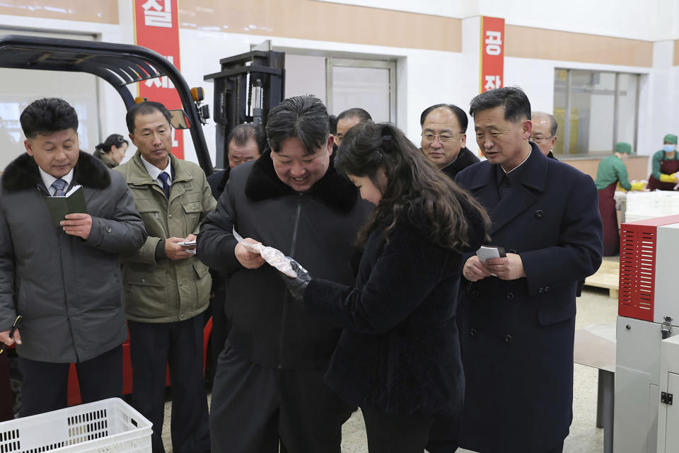 In this photo provided on Monday, Jan. 8, 2024, by the North Korean government, North Korean leader Kim Jong Un, center, with his daughter visits a newly-built chicken farm in Hwangju County of North Hwanghae Province on Jan. 7, 2024. Independent journalists were not given access to cover the event depicted in this image distributed by the North Korean government. The content of this image is as provided and cannot be independently verified. (Korean Central News Agency/Korea News Service via AP)