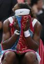 Serena Williams of the U.S. holds a towel to her face during a break in her women's singles tennis match against Alize Cornet of France at the Wimbledon Tennis Championships, in London June 28, 2014. REUTERS/Stefan Wermuth (BRITAIN - Tags: SPORT TENNIS)