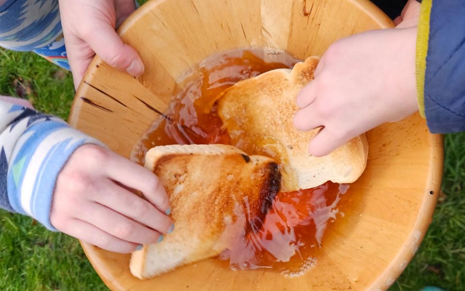 dipping toast in the wassail cup for the tree