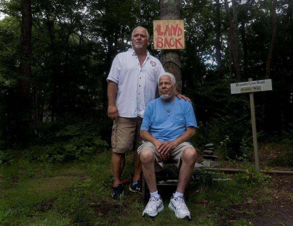 Mark Harding, left, and his 88-year-old father Wilson "Bud" Harding, right, pose for a portrait on a Monday morning. Mark Harding and his father Wilson Harding, both members of the Mashpee Wampanoag Tribe, have paid hundreds of thousands of dollars in taxes over the course of 30 years for ancestral land in Aquinnah -- land they cannot access. [Sophie Proe/Cape Cod Times]