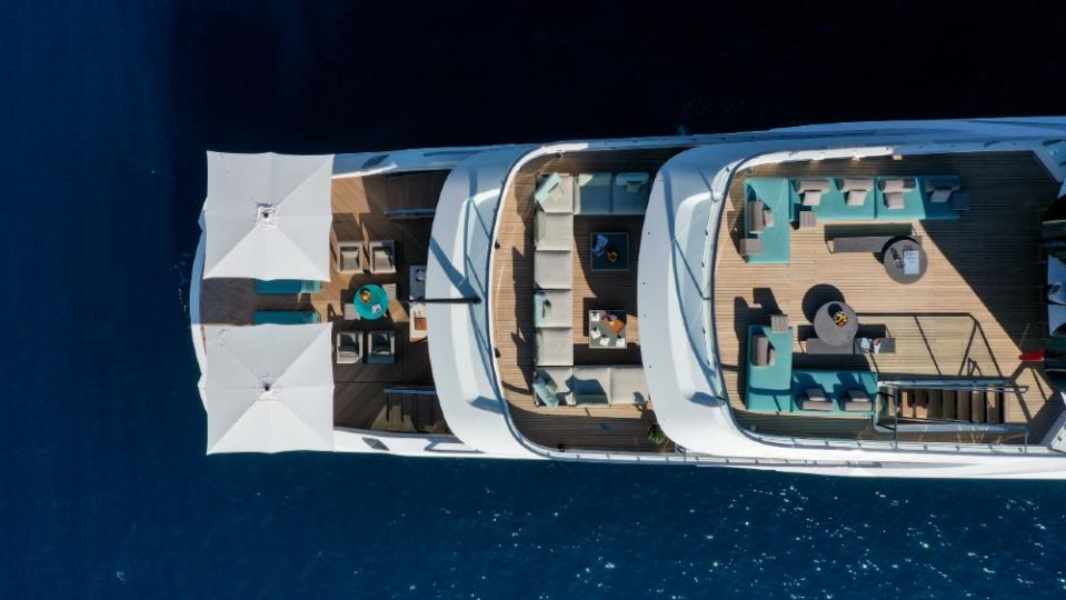 Each deck was designed for different uses. The huge swim platform at the bottom allows a large group to be near the water. The top skydeck has a full-featured outdoor galley and ice-cream machine. - Credit: Courtesy Pozitif Studio