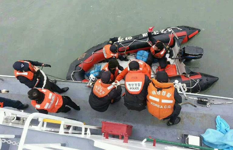 The South Korean Coast Guard rescue some of the passengers from a ferry sinking some 20 kilometres off the island of Byungpoong in Jindo on April 16, 2014, in this South Korea Coast Guard image