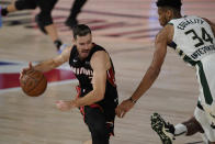 Miami Heat's Goran Dragic (7) drives around Milwaukee Bucks' Giannis Antetokounmpo (34) in the first half of an NBA conference semifinal playoff basketball game Friday, Sept. 4, 2020, in Lake Buena Vista, Fla. (AP Photo/Mark J. Terrill)