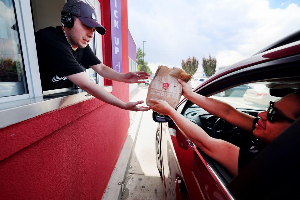 Jack in the Box employee Yair Guzman hands Edwin Santizo his food at the new Jack in the Box in Salt Lake City on Tuesday, June 27, 2023. | Scott G Winterton, Deseret News