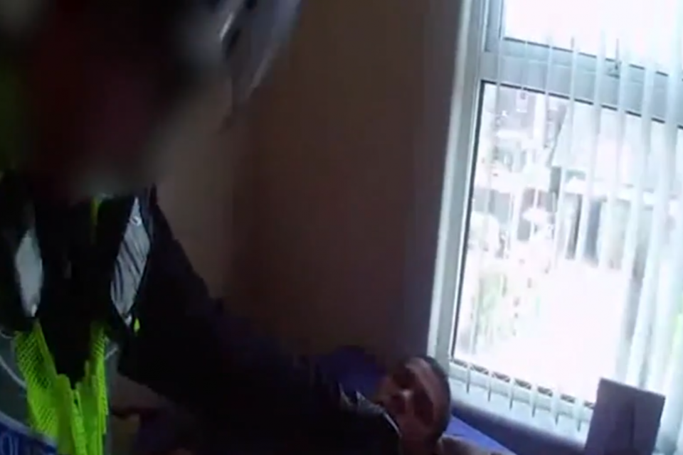 Jamil is pinned down on his bed during his arrest (Met Police)