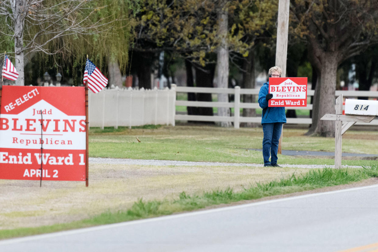 A Judd Blevins supporter waves a sign to passing cars. (Michael Noble Jr. for NBC News)