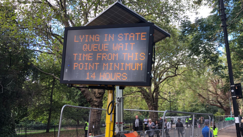 A sign warns mourners of a 14-hour wait to see Queen Elizabeth II lying in state. Ⓒ K.J. Yossman