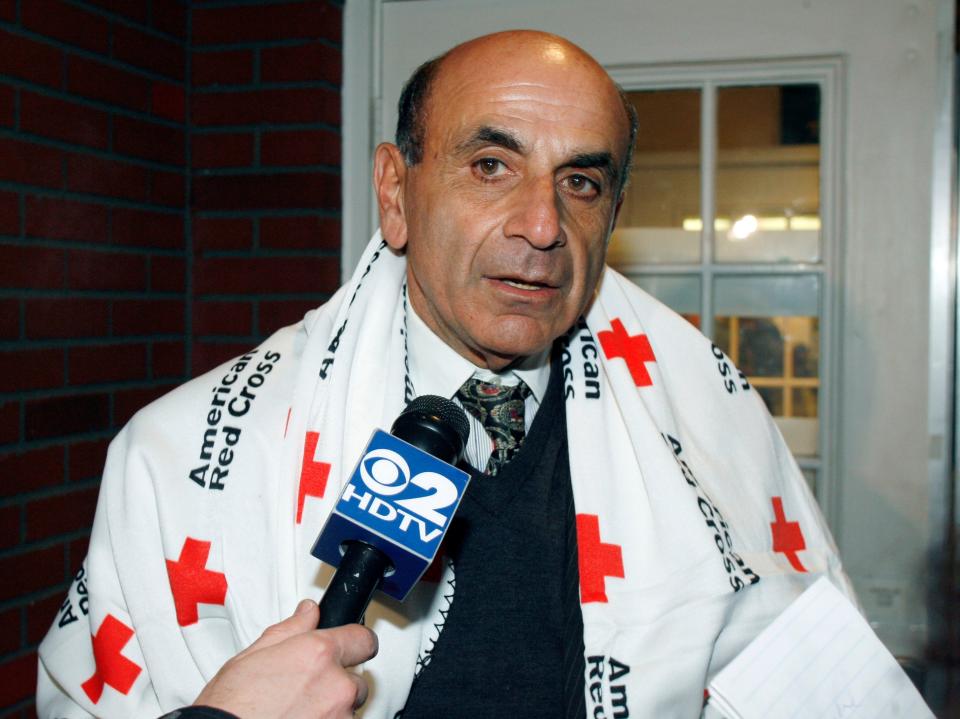 Carl Bazarian of Amelia Island, a survivor of the US Airways plane crash in the Hudson River, speaks with media as he waits for a bus to take himself and other passengers from a first-aid center in Weehawken, N.J., back to La Guardia Airport on Jan. 15, 2009.