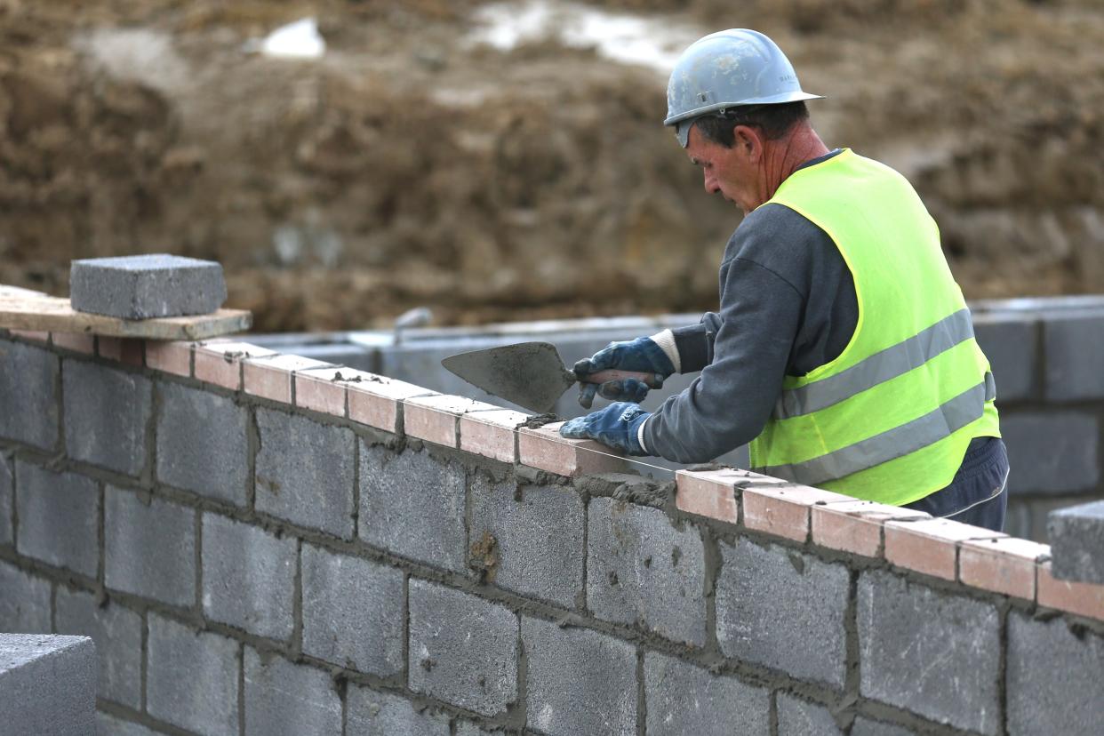 BRISTOL, UNITED KINGDOM - MARCH 18:  Construction workers continue to build new houses on a housing development on March 18, 2014 in Bristol, England.  A number of housebuilders are now constructing more homes this year than they did during the 2007 market peak, thanks to overseas investment and the government's Help to Buy scheme, which has been extended until 2020, boosting the property market and speeding up the number of new homes being built.  (Photo by Matt Cardy/Getty Images)