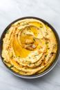 <p>Hummus is a <a href="https://www.delish.com/cooking/g39502569/middle-eastern-recipes/?slide=5" rel="nofollow noopener" target="_blank" data-ylk="slk:Middle Eastern;elm:context_link;itc:0;sec:content-canvas" class="link ">Middle Eastern</a> dish made of <a href="https://www.delish.com/cooking/recipe-ideas/g40692357/chickpea-recipes/" rel="nofollow noopener" target="_blank" data-ylk="slk:chickpeas;elm:context_link;itc:0;sec:content-canvas" class="link ">chickpeas</a> and <a href="https://www.delish.com/kitchen-tools/kitchen-secrets/a36066678/what-is-tahini/" rel="nofollow noopener" target="_blank" data-ylk="slk:tahini;elm:context_link;itc:0;sec:content-canvas" class="link ">tahini</a>. Garlic or roasted red peppers and other spices are common additions. It's great as a <a href="https://www.delish.com/cooking/recipe-ideas/a29540357/veggie-dip-recipe/" rel="nofollow noopener" target="_blank" data-ylk="slk:veggie dip;elm:context_link;itc:0;sec:content-canvas" class="link ">veggie dip</a> or with <a href="https://www.delish.com/cooking/recipe-ideas/a28143766/homemade-pita-bread/" rel="nofollow noopener" target="_blank" data-ylk="slk:pita;elm:context_link;itc:0;sec:content-canvas" class="link ">pita</a> chips for a midday snack, and the protein from the beans will keep you full 'til dinner.</p><p>Get the <strong><a href="https://www.delish.com/cooking/recipe-ideas/a20089167/best-homemade-hummus-recipe/" rel="nofollow noopener" target="_blank" data-ylk="slk:Creamy Garlic Hummus recipe;elm:context_link;itc:0;sec:content-canvas" class="link ">Creamy Garlic Hummus recipe</a></strong>.</p>