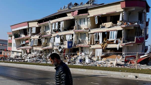 PHOTO: A man walks past a damaged building in the aftermath of a deadly earthquake in Kahramanmaras, Turkey, Feb. 13, 2023. (Suhaib Salem/Reuters)