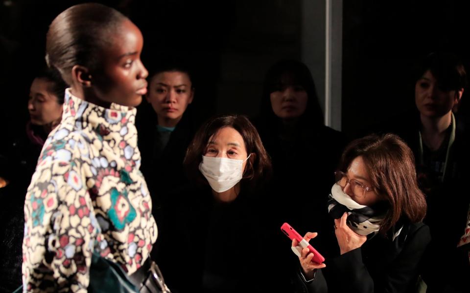 Spectators wear protective masks during the Isabel Marant fashion collection during Women's fashion week Fall/Winter 2020/21 presented in Paris - Michel Euler / AP