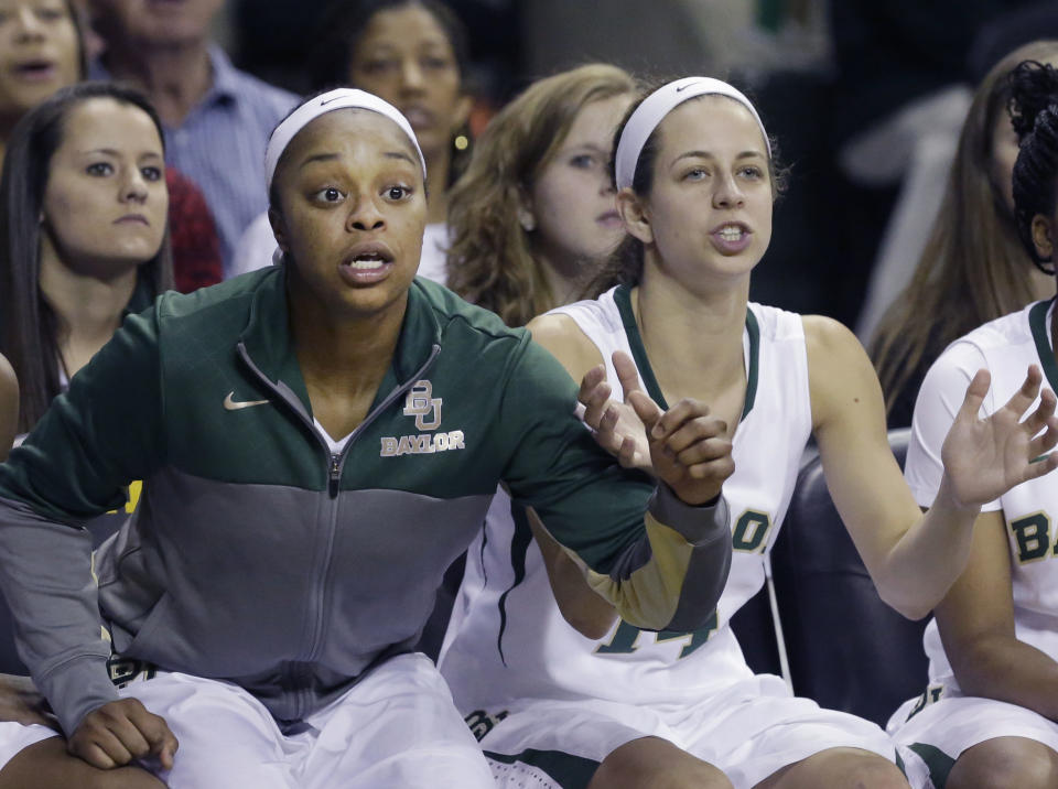 Baylor guard Odyssey Sims, left, and teammate Makenzie Robertson watch from the bench during the second half of an NCAA college basketball game against TCU, Saturday, Jan. 11, 2014, in Waco, Texas. Baylor won 80-46. (AP Photo/LM Otero)