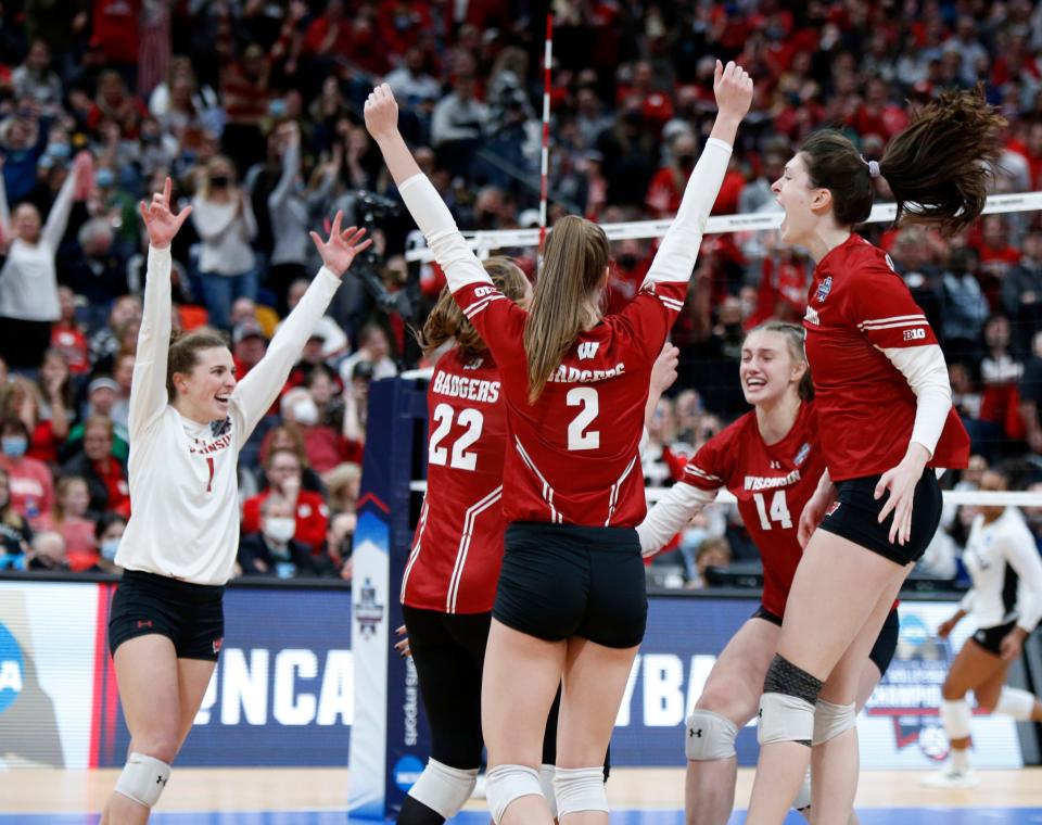 Wisconsin's Lauren Barnes (1), Julie Orzol (22), Sydney Hilley (2), Anna Smrek (14) and Dana Rettke, right, celebrate a win over Louisville in a semifinal of the NCAA women's college volleyball tournament Thursday, Dec. 16, 2021, in Columbus, Ohio.