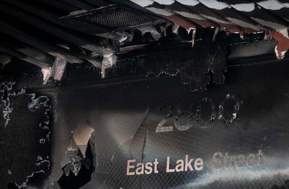 The fire-scarred address remains above the doorway of a Lake Street bank after its destruction from rioting on Sunday in Minneapolis.