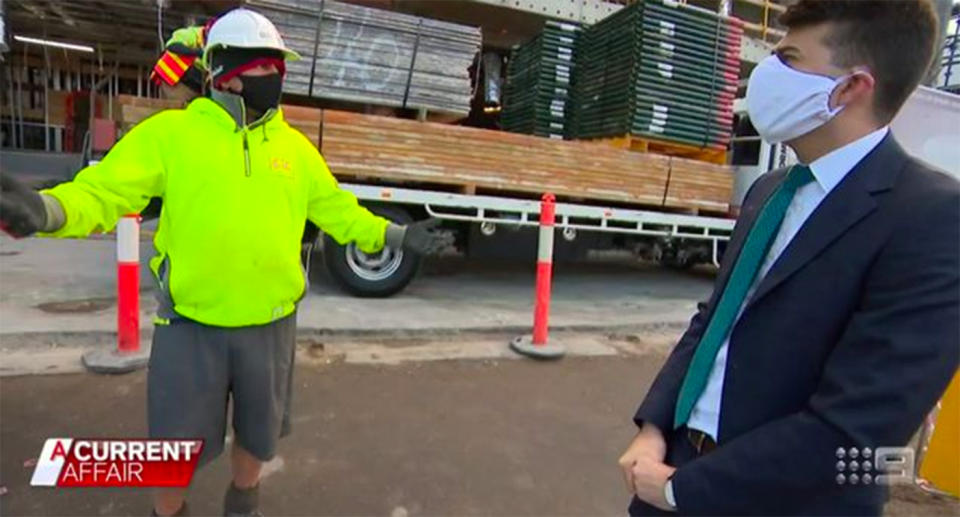 Tradesman Peter Nentis stands with a reporter on a worksite in Melbourne's inner-city.