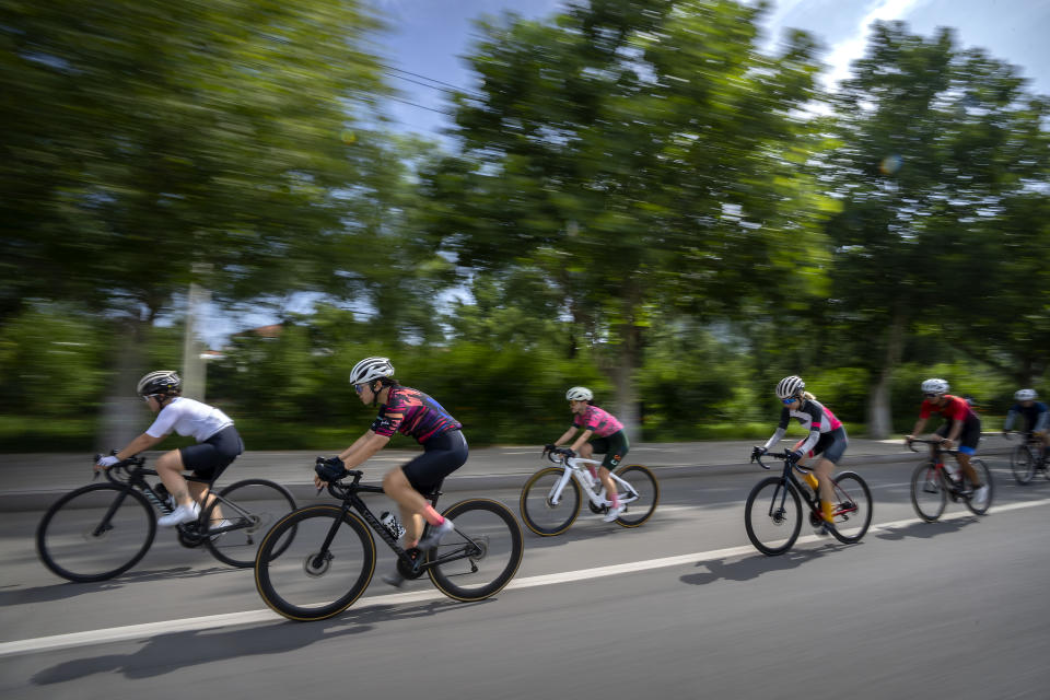 Yang Lan, second from left, and other members of the Qiyi bicycle club ride along a rural road during a group ride through the Baihe River Canyon in the northern outskirts of Beijing, Wednesday, July 13, 2022. Cycling has gained increasing popularity in China as a sport. A coronavirus outbreak that shut down indoor sports facilities in Beijing earlier this year encouraged people to try outdoor sports including cycling, which was only a major tool of transport before 2000. (AP Photo/Mark Schiefelbein)