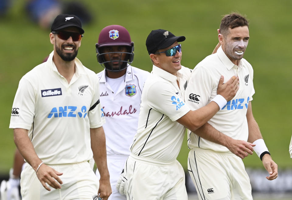 New Zealand's Tim Southee, right, is congratulated by teamates after dismissing the West Indies' John Campbell during play on day three of their first cricket test in Hamilton, New Zealand, Saturday, Dec. 5, 2020. (Andrew Cornaga/Photosport via AP)