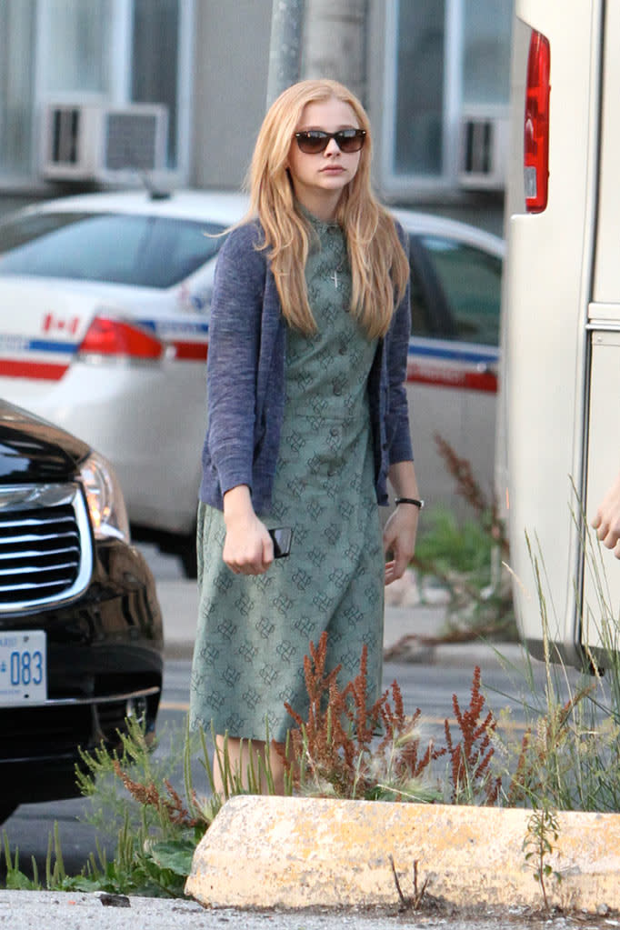 Chloe Moretz is dressed in costume as "Carrie White" while on set filming the "Carrie" remake movie in Toronto, Canada.