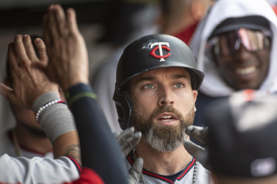 Minnesota Twins' Jake Cave is congratulated by teammates after hitting a solo home run off Cleveland Guardians starting pitcher Cody Morris during the second inning of a baseball game in Cleveland, Sunday, Sept. 18, 2022. (AP Photo/Phil Long)