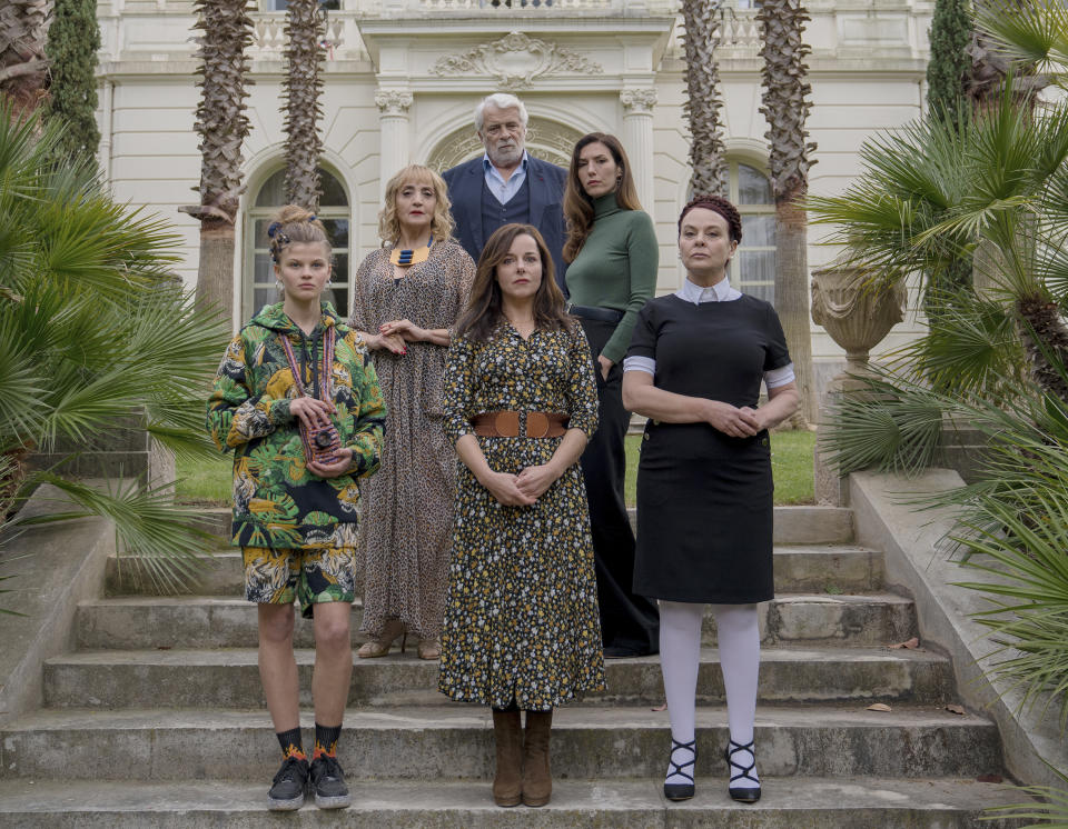 This image released by IFC Films shows, from left, Céléste Brunnquell as “Jeanne”, Dominique Blanc as “Eugénie”, Laure Calamy as “Stéphane”, foreground center, Jacques Weber as “Serge”, background center, Doria Tilllier as “George” and Véronique Ruggia Saura in a scene from "The Origin of Evil." (Laurent Champoussin/IFC Films via AP)