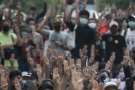 Pro-democracy demonstrators raise a three-finger salute, a symbol of resistance, during a protest outside the Parliament in Bangkok, Thailand, Thursday, Sept. 24, 2020. Lawmakers in Thailand are expected to vote Thursday on six proposed amendments to the constitution, as protesters supporting pro-democratic charter reforms gathered outside the parliament building. (AP Photo/Sakchai Lalit)