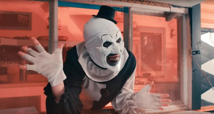 Art the Clown waves his hands in Terrifier 2.