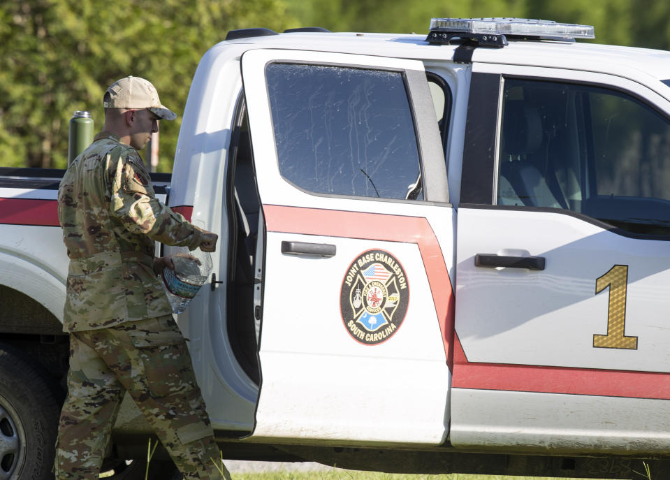 Airmen from Joint Base Charleston coordinate at the crash site of an F-35 to recover the fighter jet in Williamsburg County, S.C., on Monday, Sept. 18, 2023. (Henry Taylor/The Post And Courier via AP)