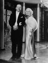 <p>Hollywood's original blonde bombshell, Jean Harlow, was playing Kitty Packard in <em>Dinner at Eight </em>when she wore this caped silk slipdress and white fur stole, but it could have just as easily been worn by the starlet herself.  </p>