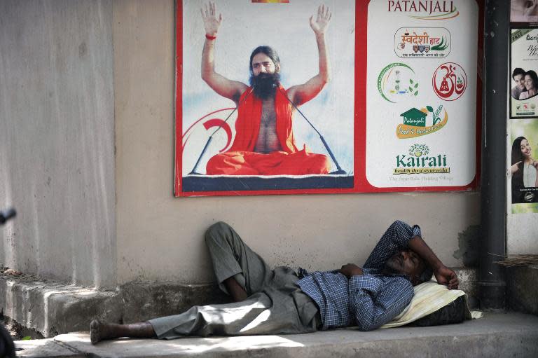An Indian man rests in the shade to escape soaring temperatures in Hyderabad on May 26, 2015