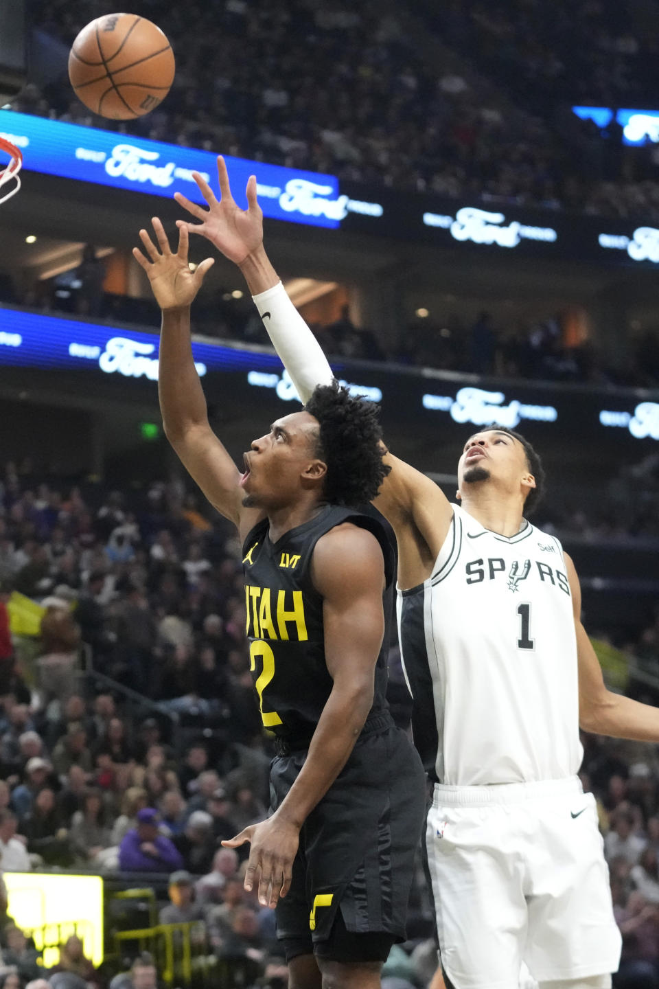 Utah Jazz guard Collin Sexton (2) shoots as San Antonio Spurs center Victor Wembanyama (1) defends during the first half of an NBA basketball game Wednesday, March 27, 2024, in Salt Lake City. (AP Photo/Rick Bowmer)