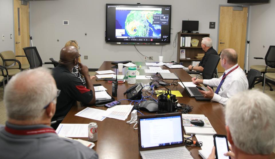 Volusia County officials including interim Emergency Management Director Jim Judge, far right, and Community Information Director Kevin Captain, to his right, monitor Hurricane Ian in the Emergency Operations Center in Daytona Beach on Wednesday.