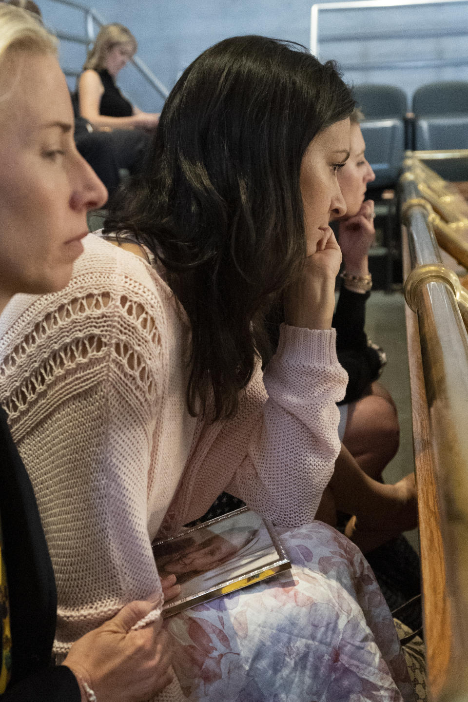 Katy Dieckhaus, mother of Covenant School shooting victim Evelyn Dieckhaus, with a picture of her daughter on her lap, attends a legislative session of the state Senate, Thursday, April 20, 2023, in Nashville, Tenn. (AP Photo/George Walker IV)