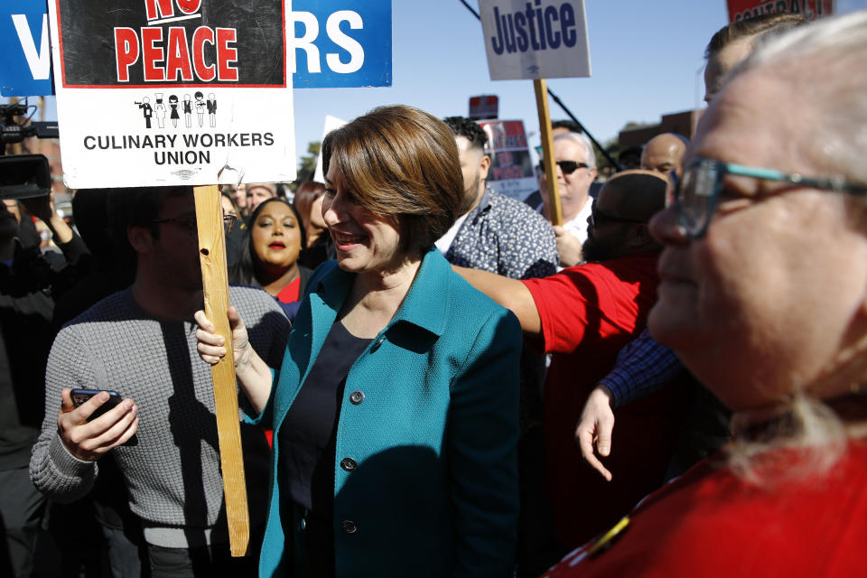 Democratic presidential candidate Sen. Amy Klobuchar, D-Minn., walks on a picket line with members of the Culinary Workers Union Local 226 outside the Palms Casino in Las Vegas, Wednesday, Feb. 19, 2020. (AP Photo/Patrick Semansky)