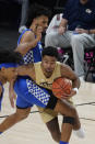 Georgia Tech guard Kyle Sturdivant (1) works to get around Kentucky forward Olivier Sarr, top, during the second half of an NCAA college basketball game Sunday, Dec. 6, 2020, in Atlanta. (AP Photo/John Bazemore)