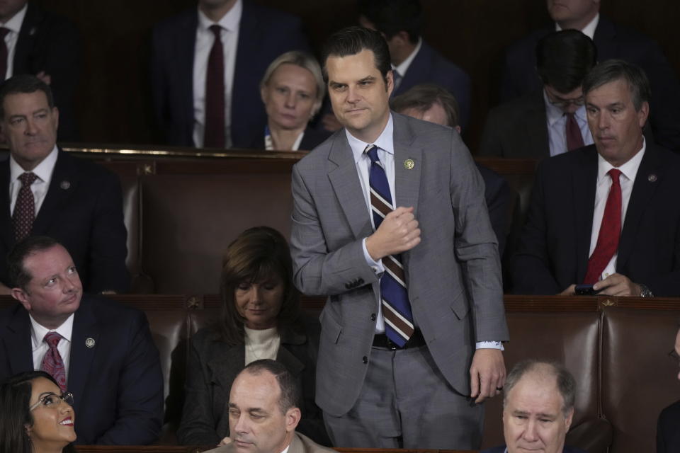 Rep. Matt Gaetz, R-Fla., stands to vote for Rep. Mike Johnson, R-La., in the House Chamber, as Republican members try to elect a speaker, at the Capitol in Washington, Wednesday, Oct. 25, 2023.