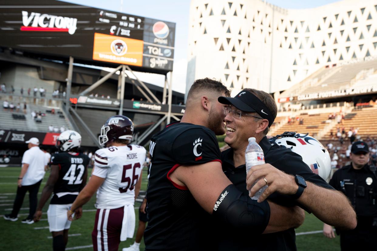 Cincinnati Bearcats head coach Scott Satterfield embraces Cincinnati Bearcats offensive lineman Luke Kandra (67) after the NCAA football game between the Cincinnati Bearcats and the Eastern Kentucky Colonels at Nippert Stadium in Cincinnati on Saturday, Sept. 2, 2023.