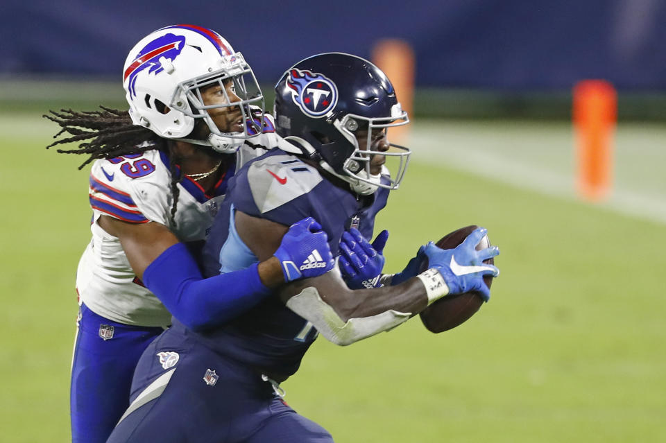 Tennessee Titans wide receiver A.J. Brown (11) is stopped by Buffalo Bills cornerback Josh Norman (29) in the second half of an NFL football game Tuesday, Oct. 13, 2020, in Nashville, Tenn. (AP Photo/Wade Payne)