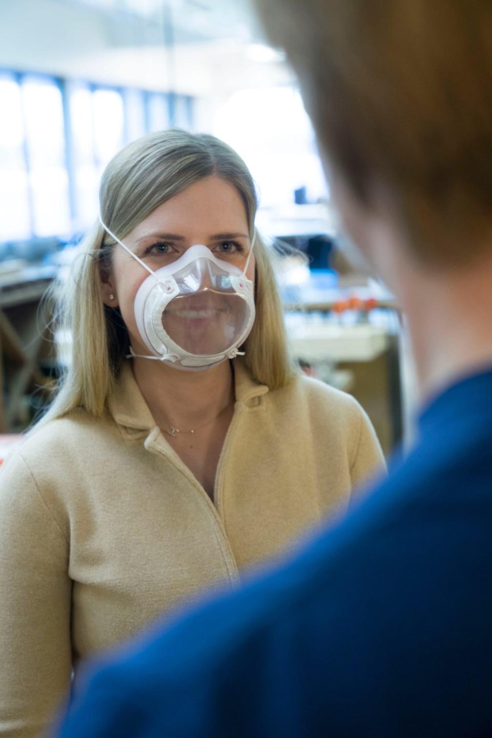 Hana Forbes, left, and Will Brick work try on the new Ford clear N 95 respirator masks.